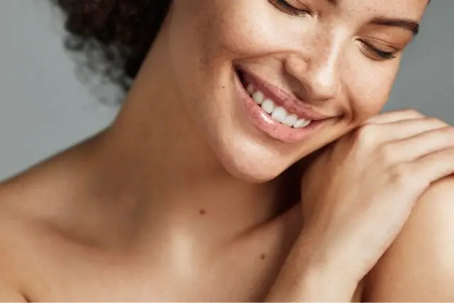 Close-up of smiling woman with freckles